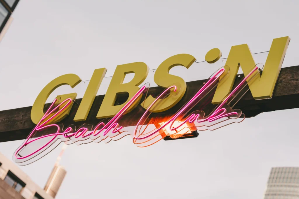 Gibson Beach Club Eingang mit Logo Grün Pink
