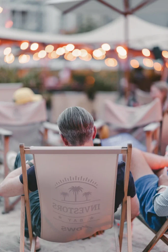 Mann sitzt im Strandstuhl in der Strandbar